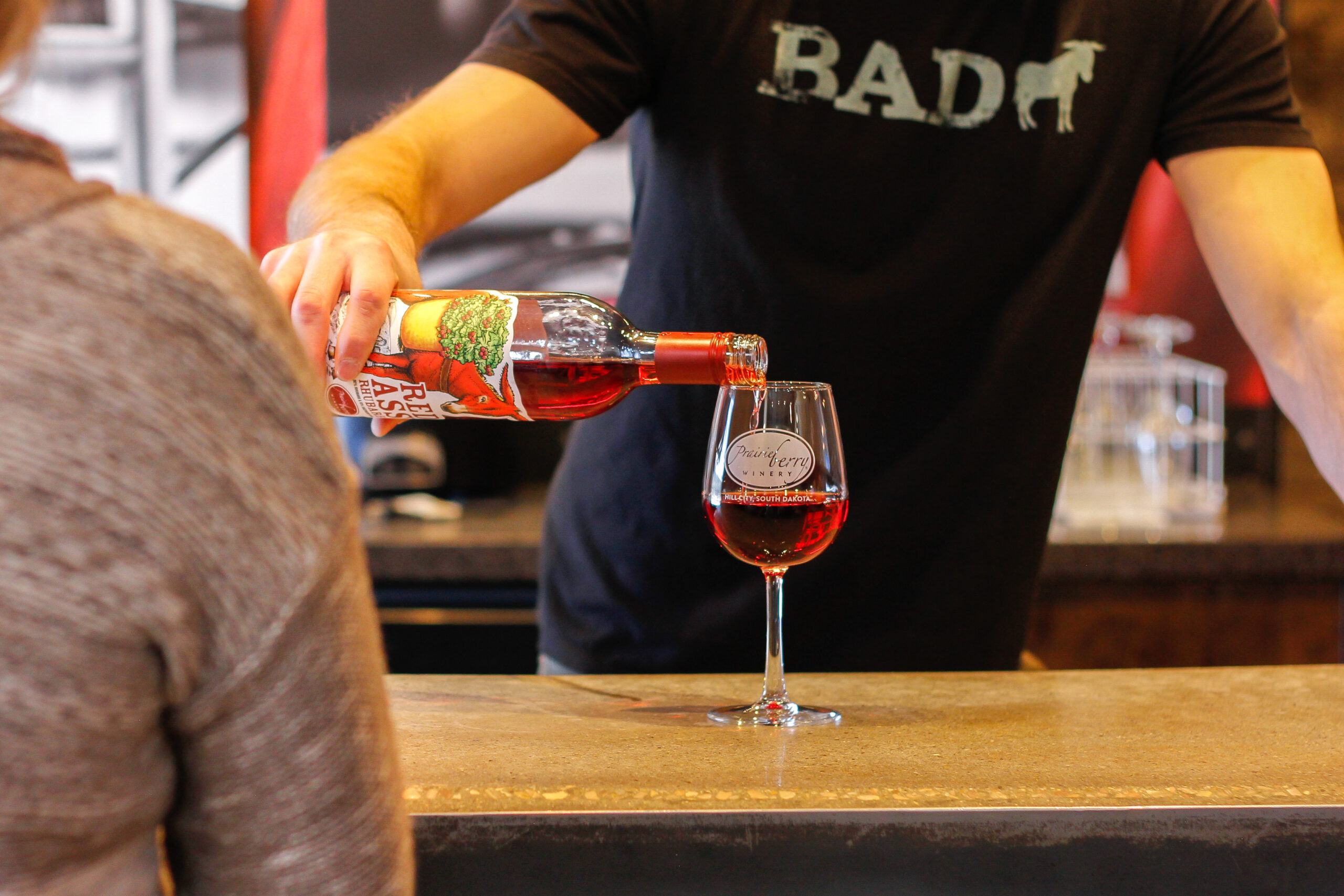 Picture of a Workamper pouring wine at Prairie Berry Winery