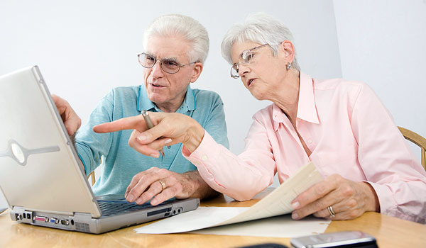 Image of an older couple looking at a laptop