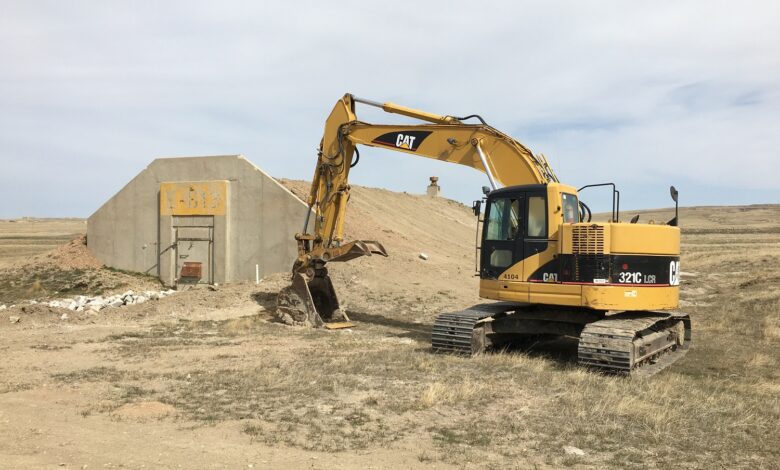 Image of an earth mover near an underground shelter in South Dakota