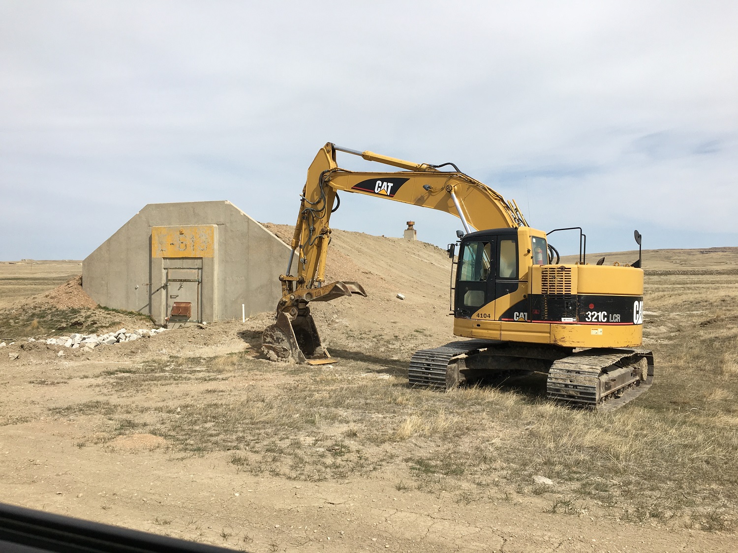 Image of an earth mover near an underground shelter in South Dakota