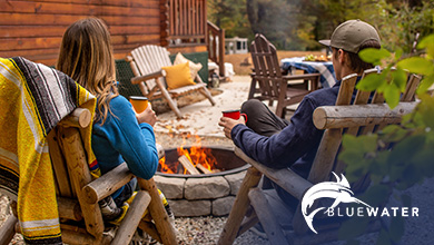 Photo of a couple sitting by a campfire