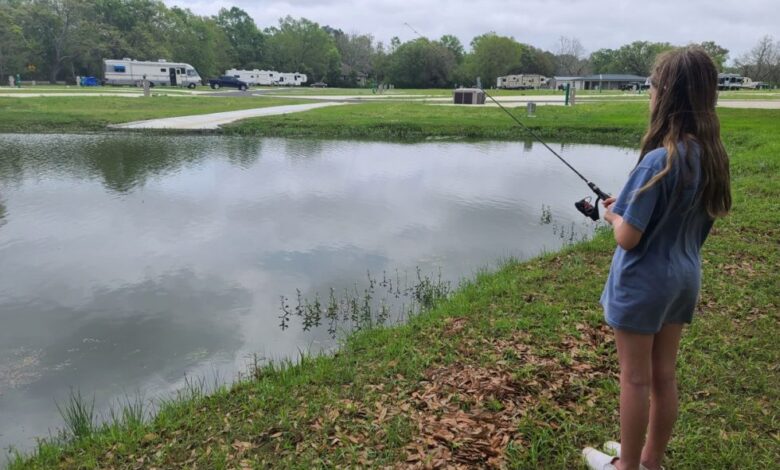 Photo of a young woman fishing at Homestead RV Community.