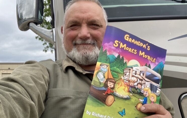 Photo of Richard Duhaime and his children's book "Grandpa's S'Mores Mobile."