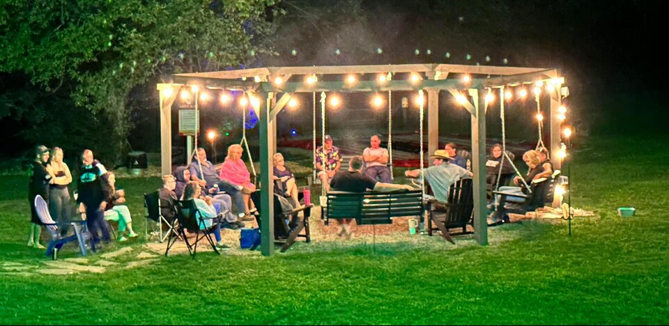 Photo of guests enjoying a summer night at Pleasant Hill Campground in Hermon, Maine.