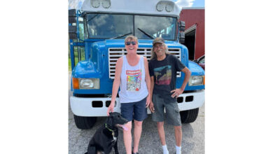 Mandy and Allen Hallengren in front of their converted school bus.