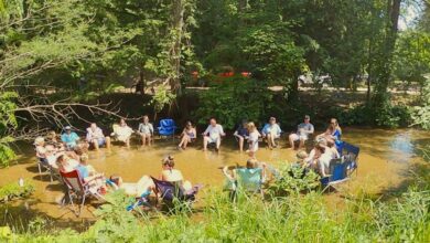 Guests relax in Sand Creek at White River RV Park and Campground in Montague, Mich.