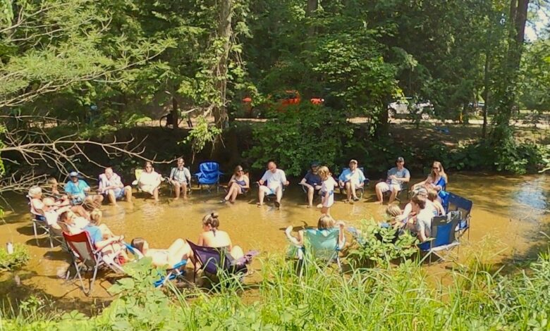 Guests relax in Sand Creek at White River RV Park and Campground in Montague, Mich.