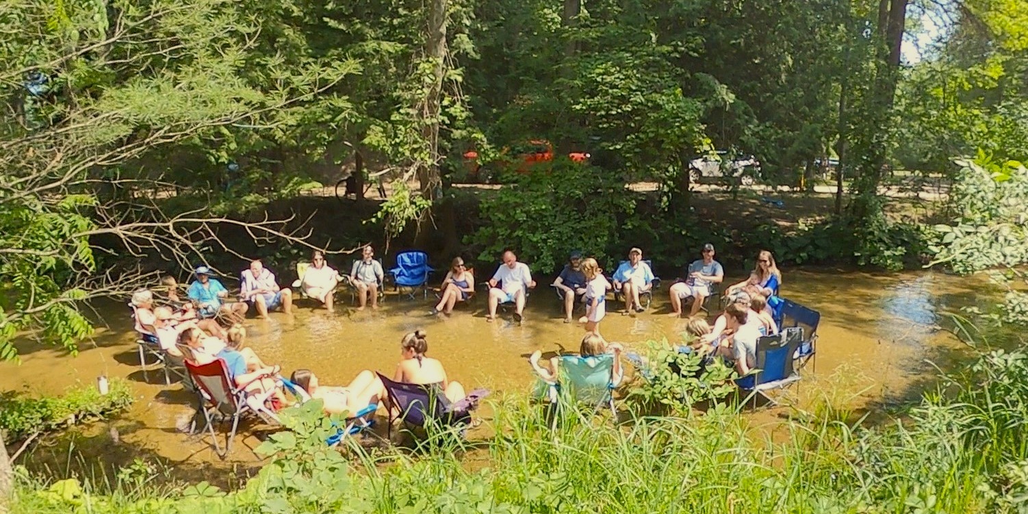 Guests relax in Sand Creek at White River RV Park and Campground in Montague, Mich.